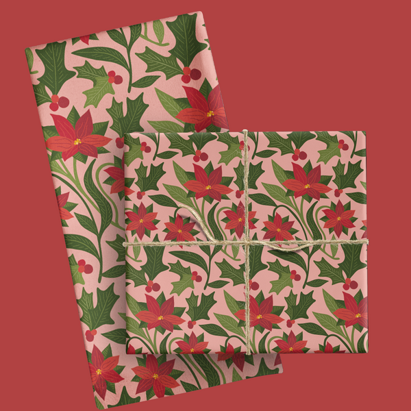 Floral patterned tea towel with pionsettia and green leaves on a pink background